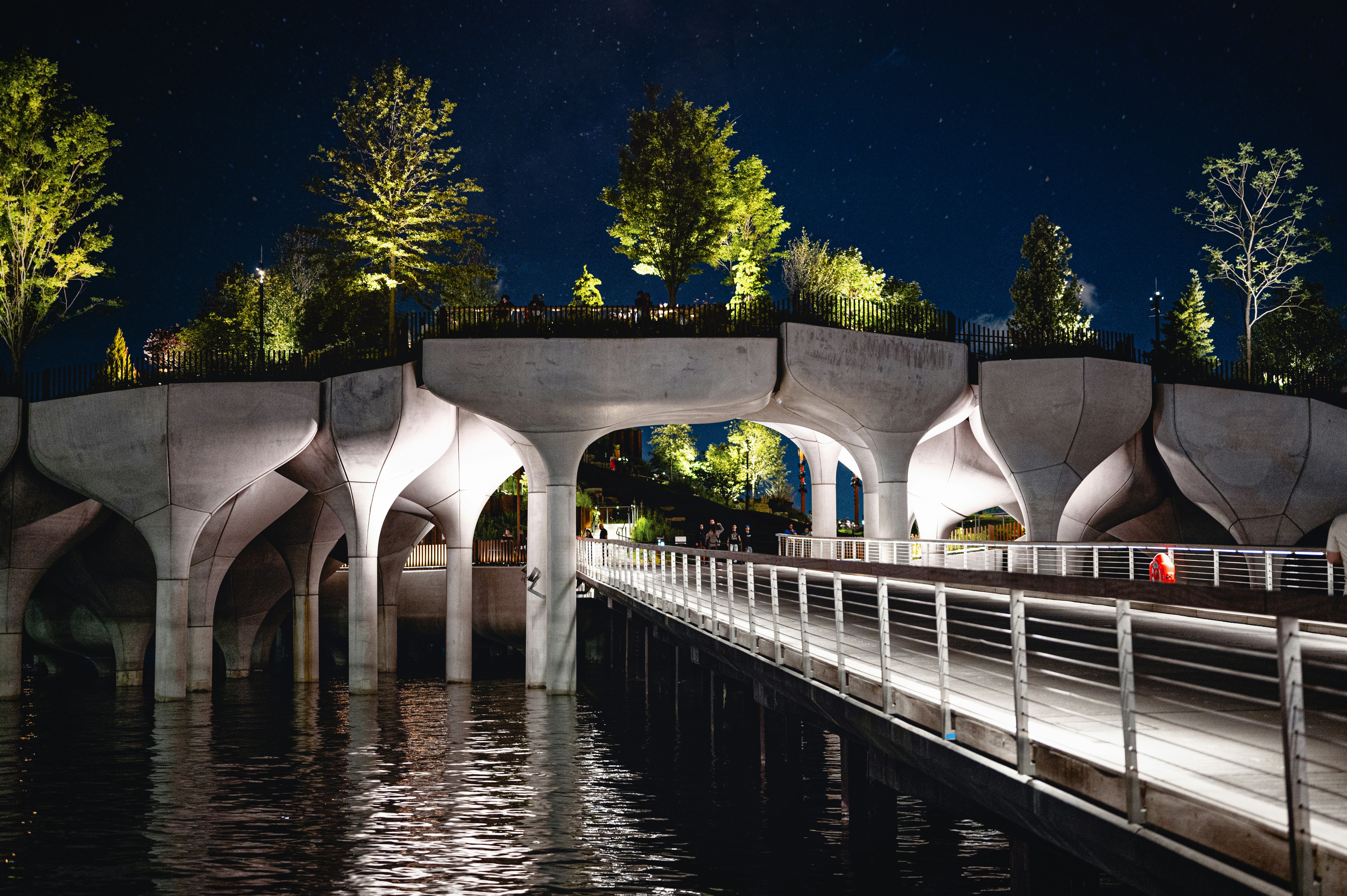 white concrete bridge over river during night time